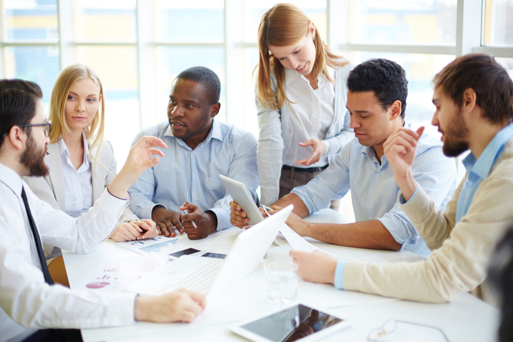 Group of confident business partners interacting at meeting