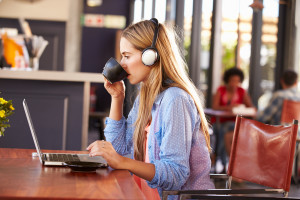 Young woman using computer at a coffee shop